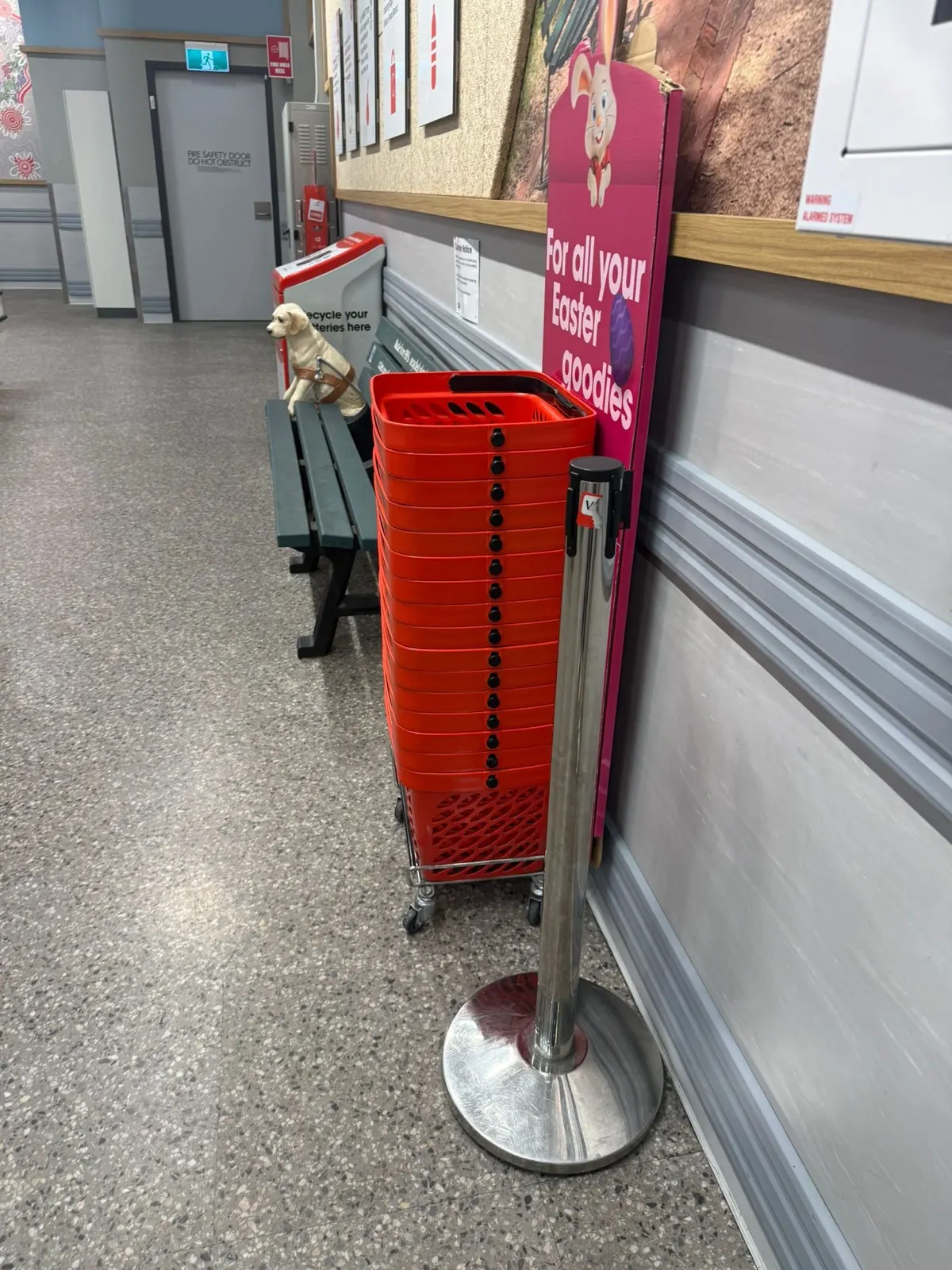 Partially obscured battery recovery point beside stacked red baskets and other fixtures