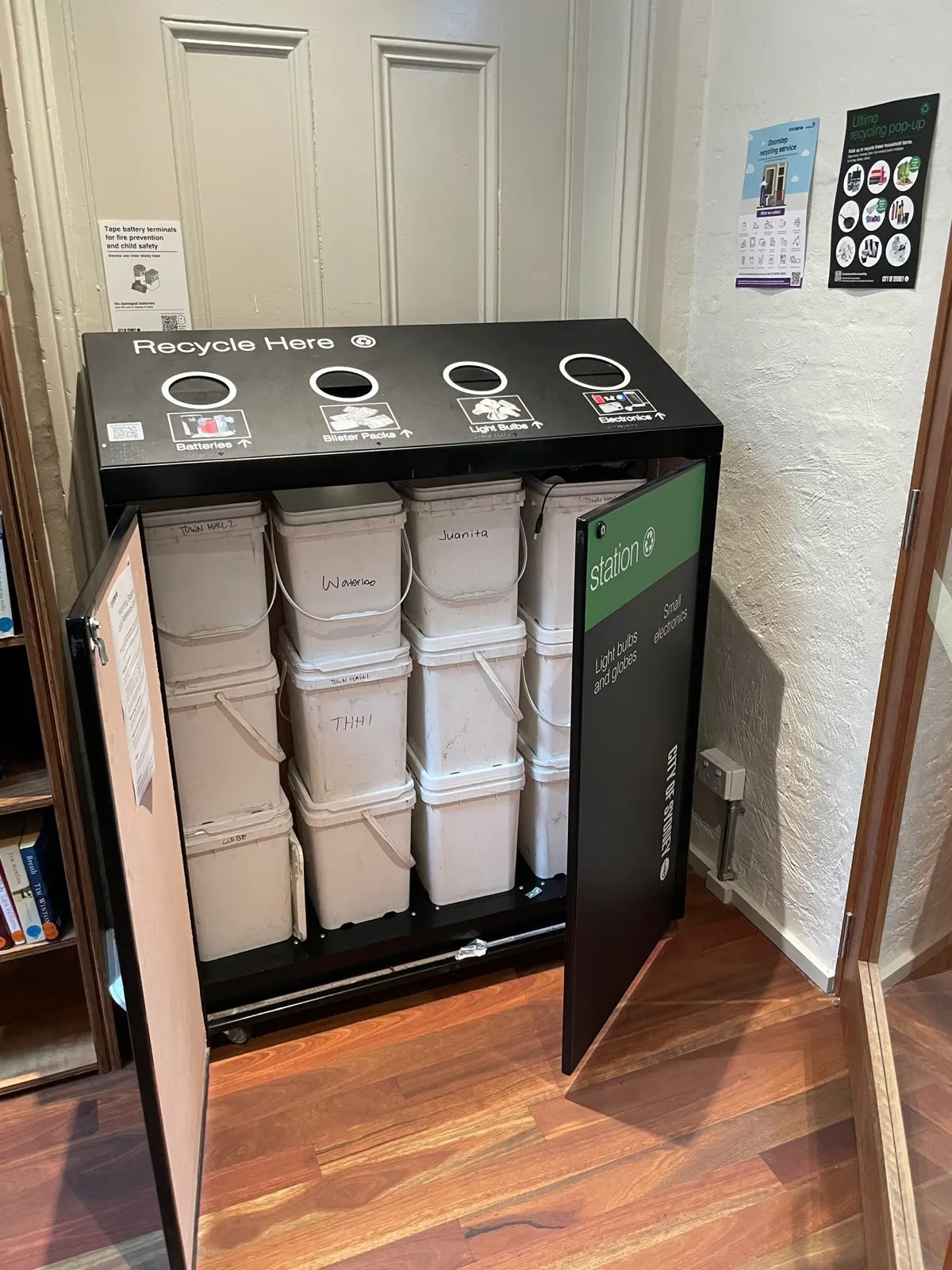 Open multi-stream recycling station showing internal collection buckets